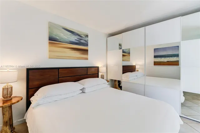 a bedroom with a bed and a view of kitchen