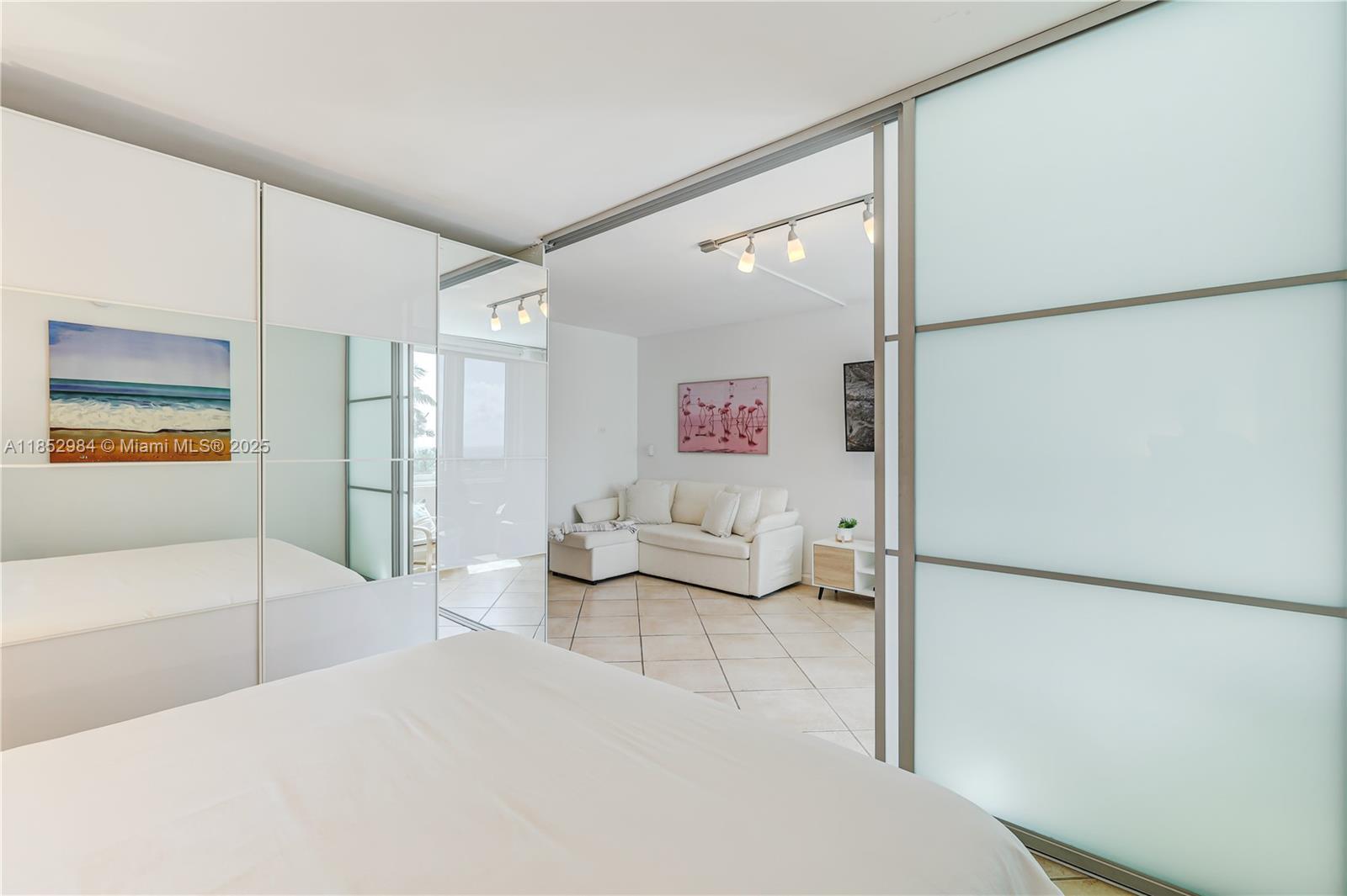 2301 Collins Avenue, Unit 523 Miami Beach, FL 33139 - Photo 26 of 49 a bedroom with a bed and a refrigerator