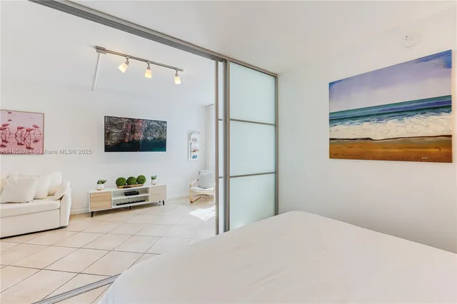 a bedroom with a bed and a flat screen tv