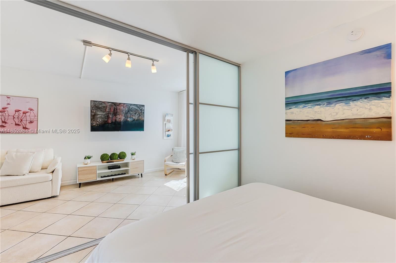 2301 Collins Avenue, Unit 523 Miami Beach, FL 33139 - Photo 27 of 49 a bedroom with a bed and a flat screen tv