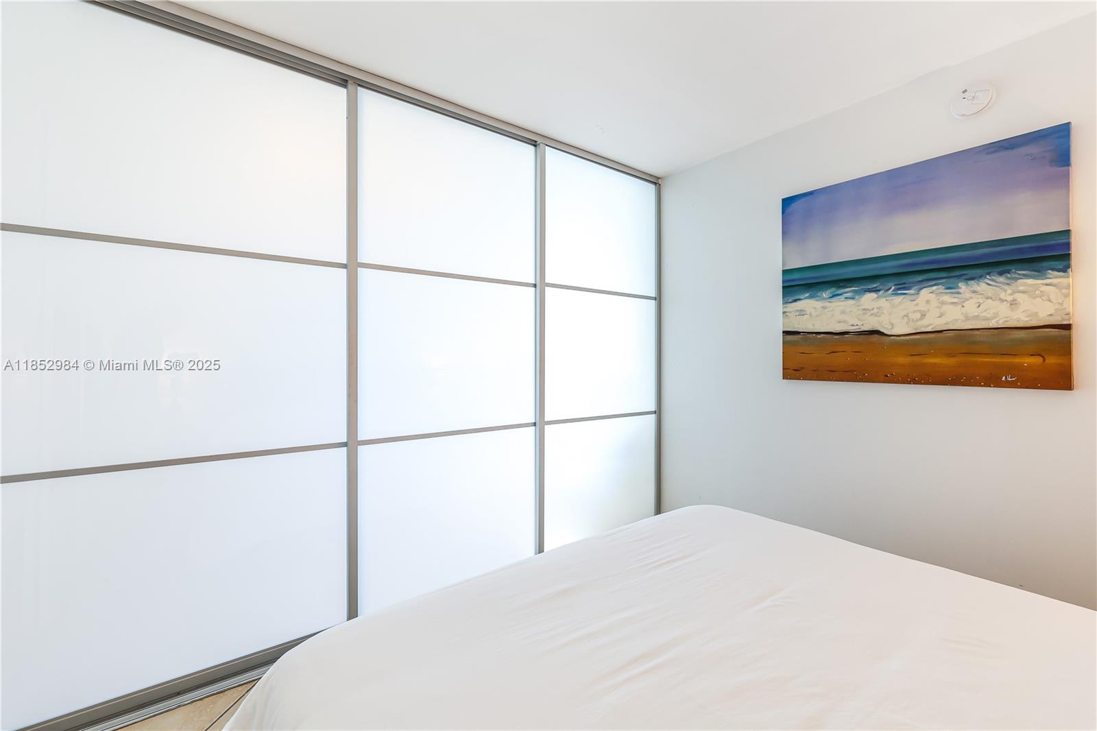 2301 Collins Avenue, Unit 523 Miami Beach, FL 33139 - Photo 28 of 49 a bedroom with a bed and a painting on the wall