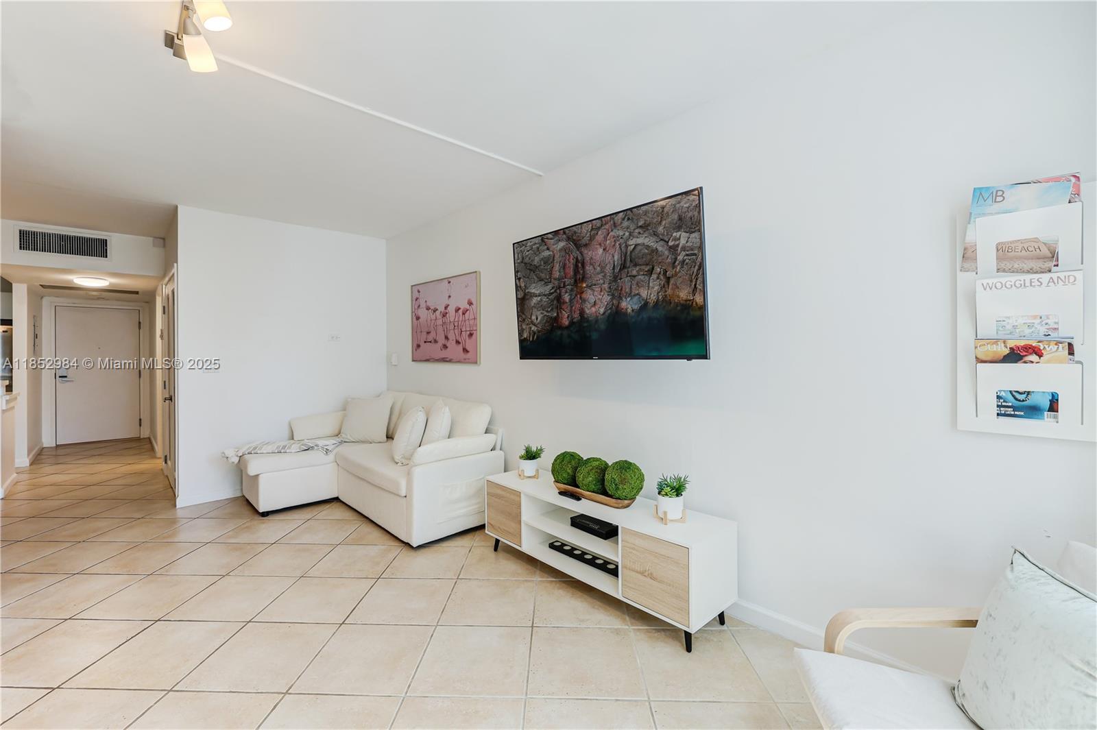 2301 Collins Avenue, Unit 523 Miami Beach, FL 33139 - Photo 29 of 49 a living room with furniture and a rug