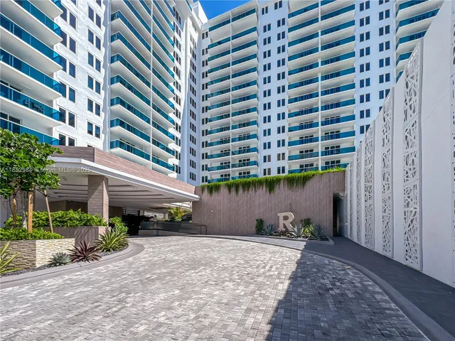 a front view of a building with a garden