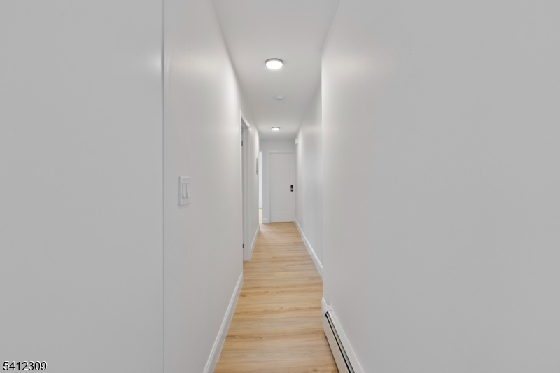676 Chestnut Street, Unit 1 Kearny, NJ 07032 - Photo 13 of 27 a view of a hallway with wooden floor