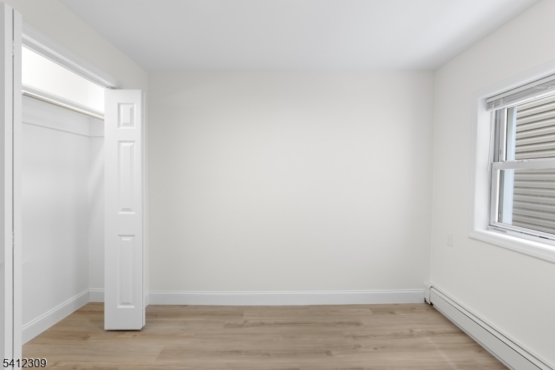 676 Chestnut Street, Unit 1 Kearny, NJ 07032 - Photo 15 of 27 a view of empty room with wooden floor and fan