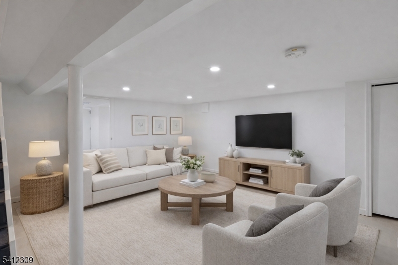 676 Chestnut Street, Unit 1 Kearny, NJ 07032 - Photo 4 of 27 a living room with furniture a flat screen tv and a window