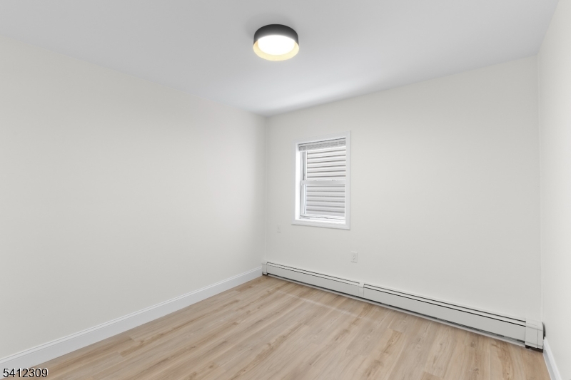 676 Chestnut Street, Unit 1 Kearny, NJ 07032 - Photo 7 of 27 an empty room with a window