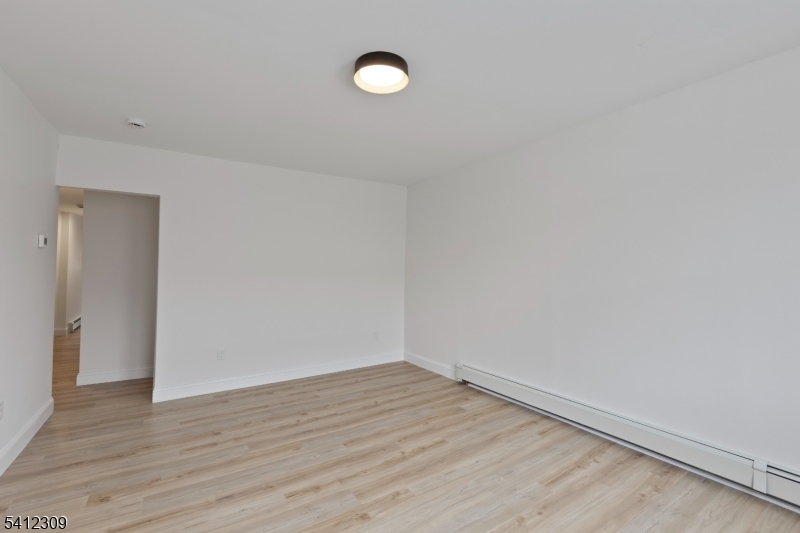 676 Chestnut Street, Unit 1 Kearny, NJ 07032 - Photo 8 of 27 a view of a room with wooden floor
