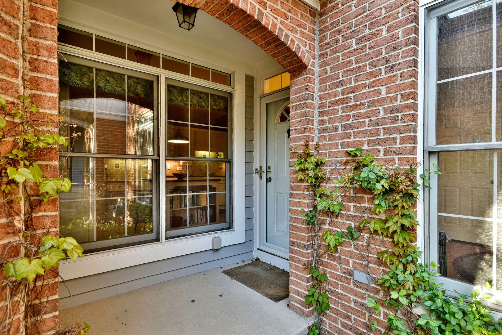 a view of front door of house with potted plant windows