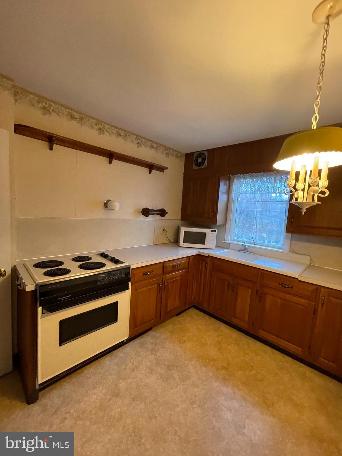 435 Sycamore Road Reading, PA 19611 - Photo 8 of 14 a kitchen with stainless steel appliances granite countertop a stove a sink and a refrigerator