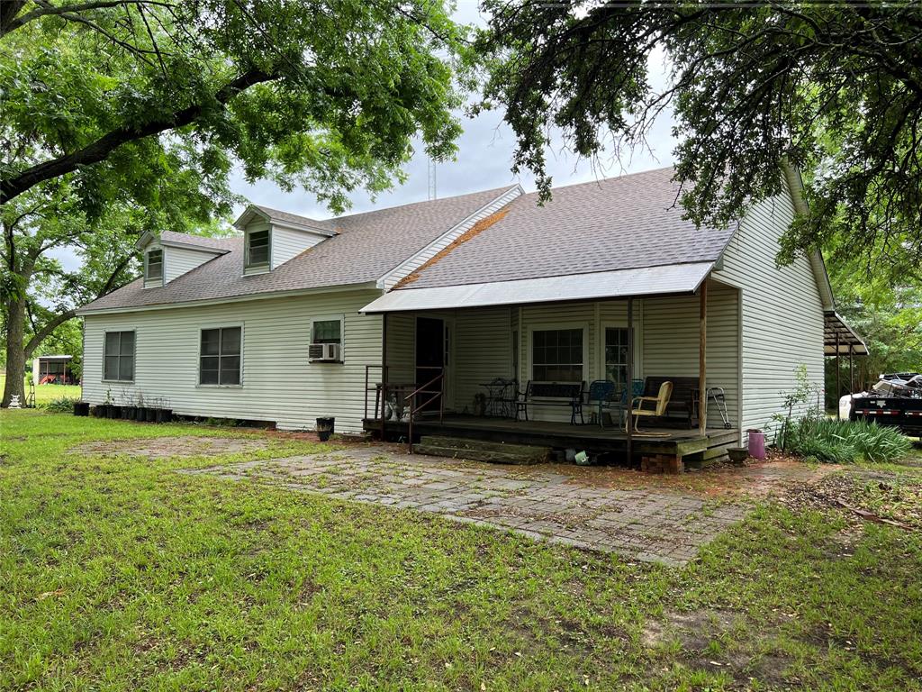 a view of a house with backyard sitting area and garden