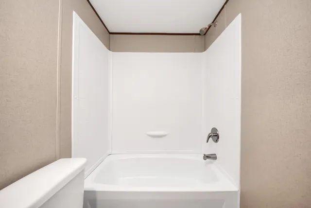 a bathroom with a bathtub and a shower curtain