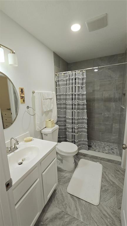 2207 Julianna Court St. Cloud, FL 34769 - Photo 11 of 11 a bathroom with a sink a toilet and shower