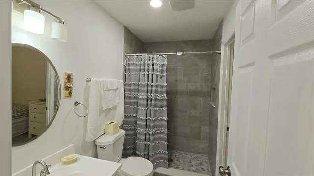 a bathroom with a shower and a toilet