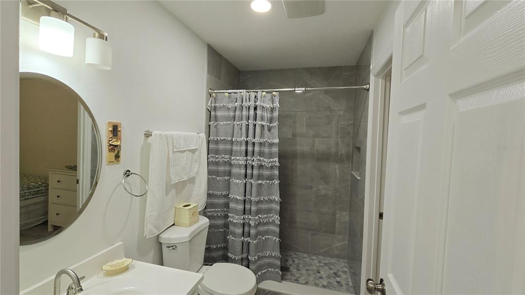 2207 Julianna Court St. Cloud, FL 34769 - Photo 10 of 11 a bathroom with a shower and a toilet