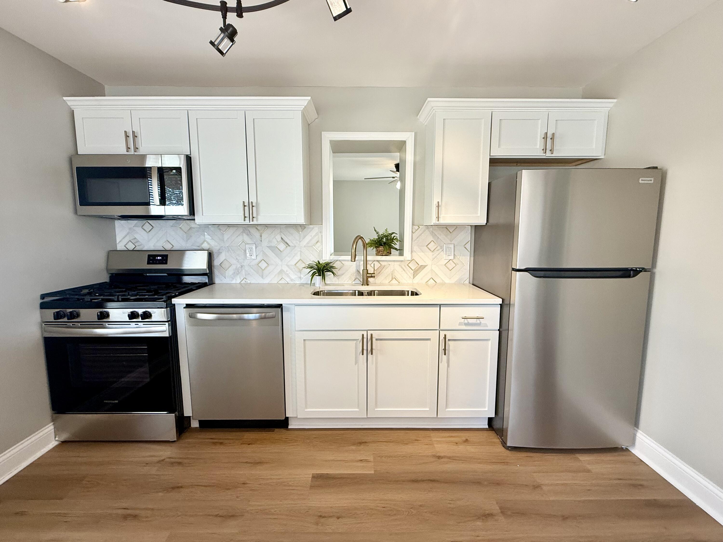 539 North Raymond Street Griffith, IN 46319 - Photo 5 of 24 a kitchen with white cabinets and white appliances