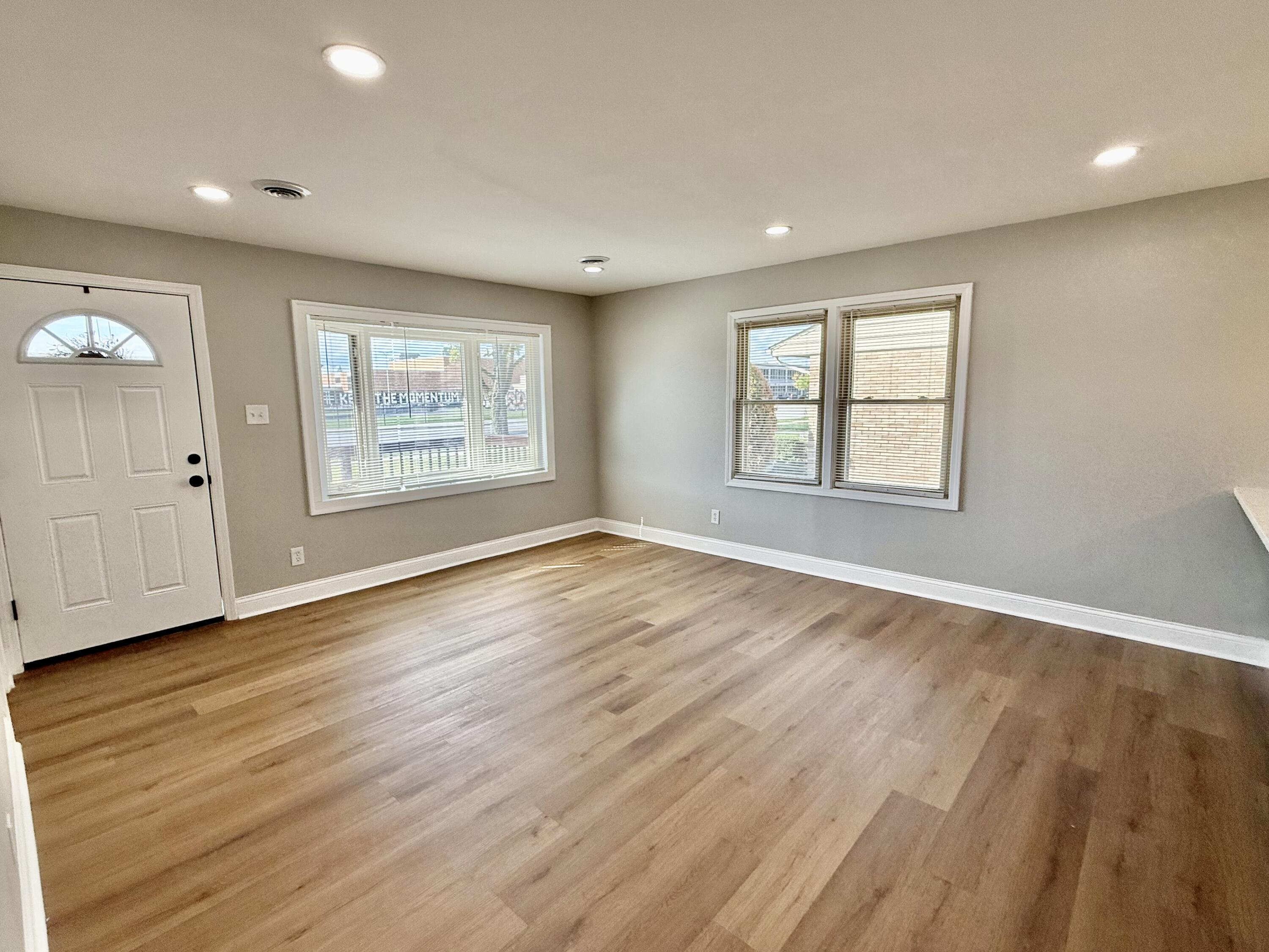 539 North Raymond Street Griffith, IN 46319 - Photo 7 of 24 an empty room with wooden floor and windows