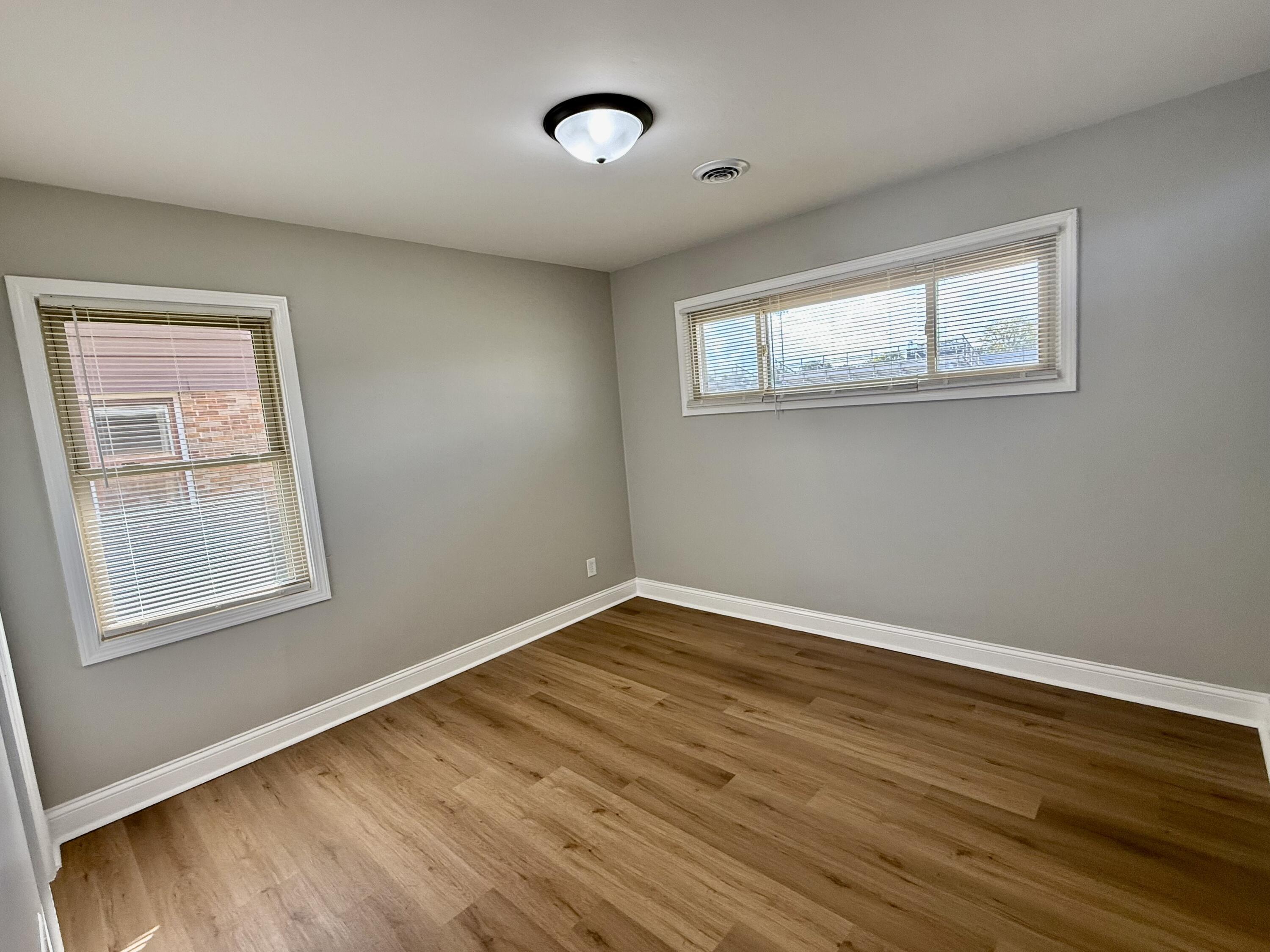 539 North Raymond Street Griffith, IN 46319 - Photo 8 of 24 an empty room with wooden floor and windows