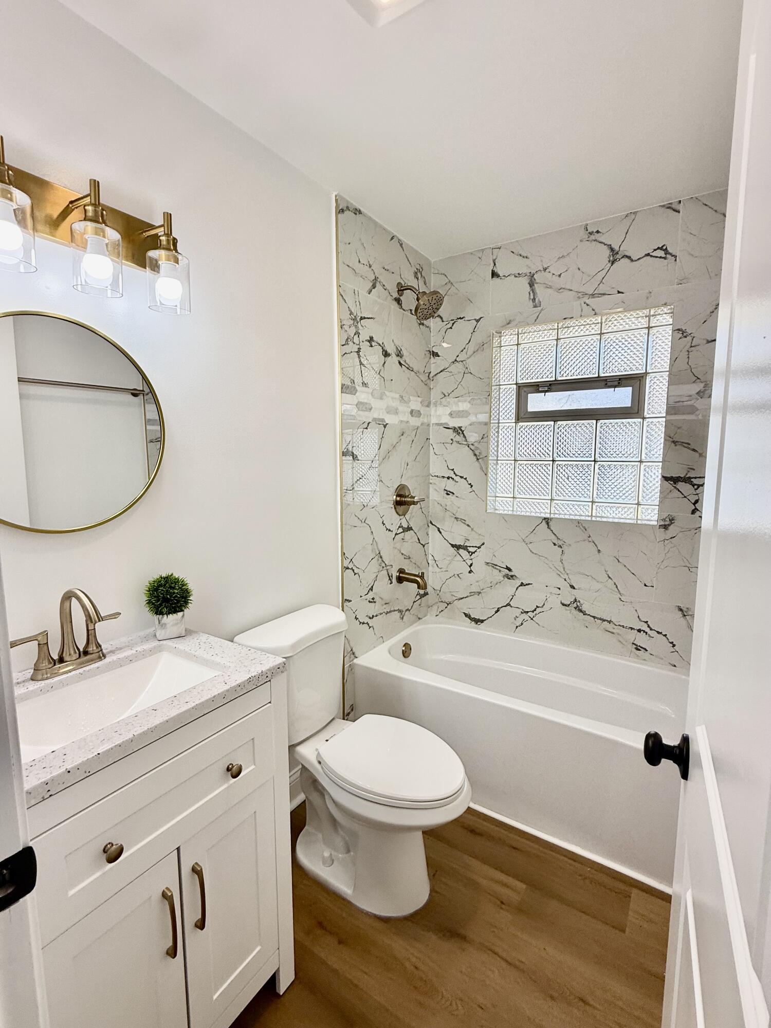 539 North Raymond Street Griffith, IN 46319 - Photo 9 of 24 a bathroom with a sink a toilet and shower