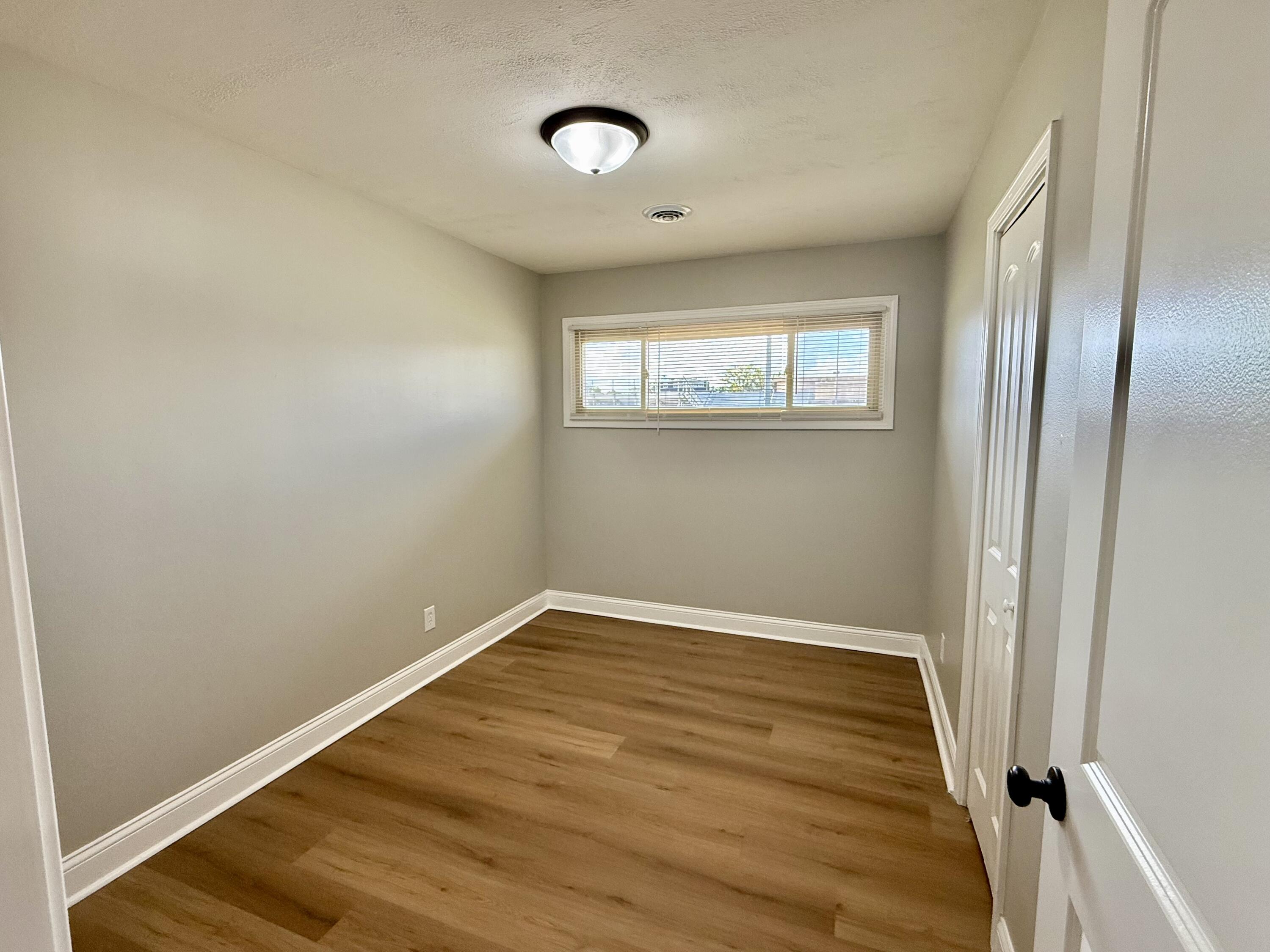 539 North Raymond Street Griffith, IN 46319 - Photo 10 of 24 an empty room with wooden floor and windows