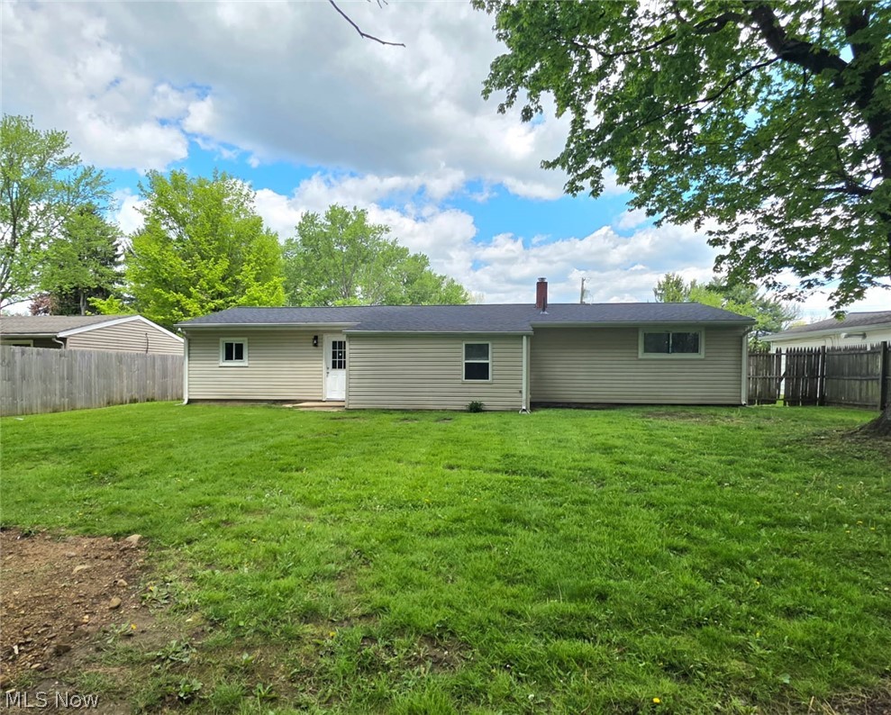 3070 Polly Road Ravenna, OH 44266 - Photo 35 of 38 Expansive green lawn with a tan siding exterior and dark shingle roof