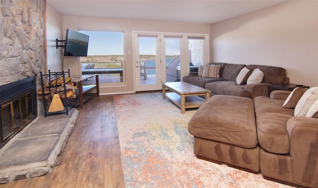 3109 Hells Gate Loop, Unit 59 Strawn, TX 76475 - Photo 1 of 25 a living room with furniture and a fireplace