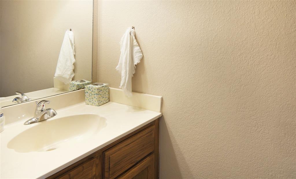3109 Hells Gate Loop, Unit 59 Strawn, TX 76475 - Photo 14 of 25 a bathroom with a sink and a mirror