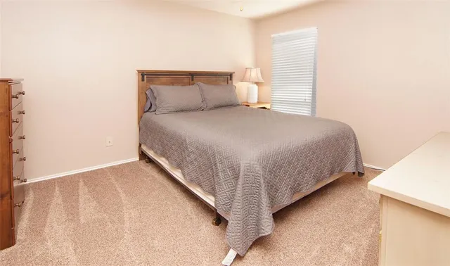 a bedroom with a bed and a night stand