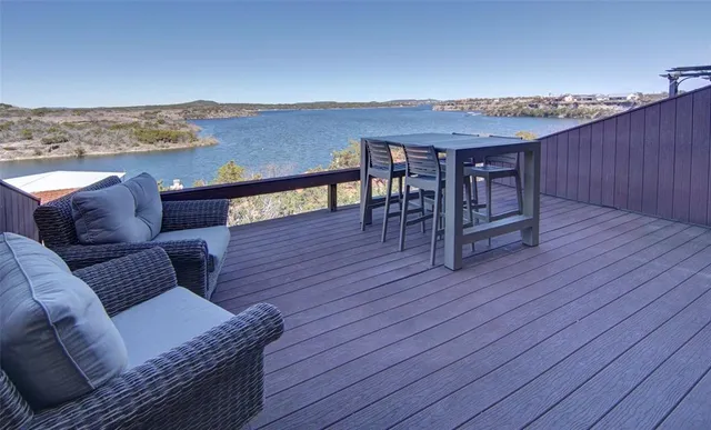 a roof deck with couches and wooden floor