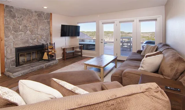 a living room with furniture a fireplace and a flat screen tv