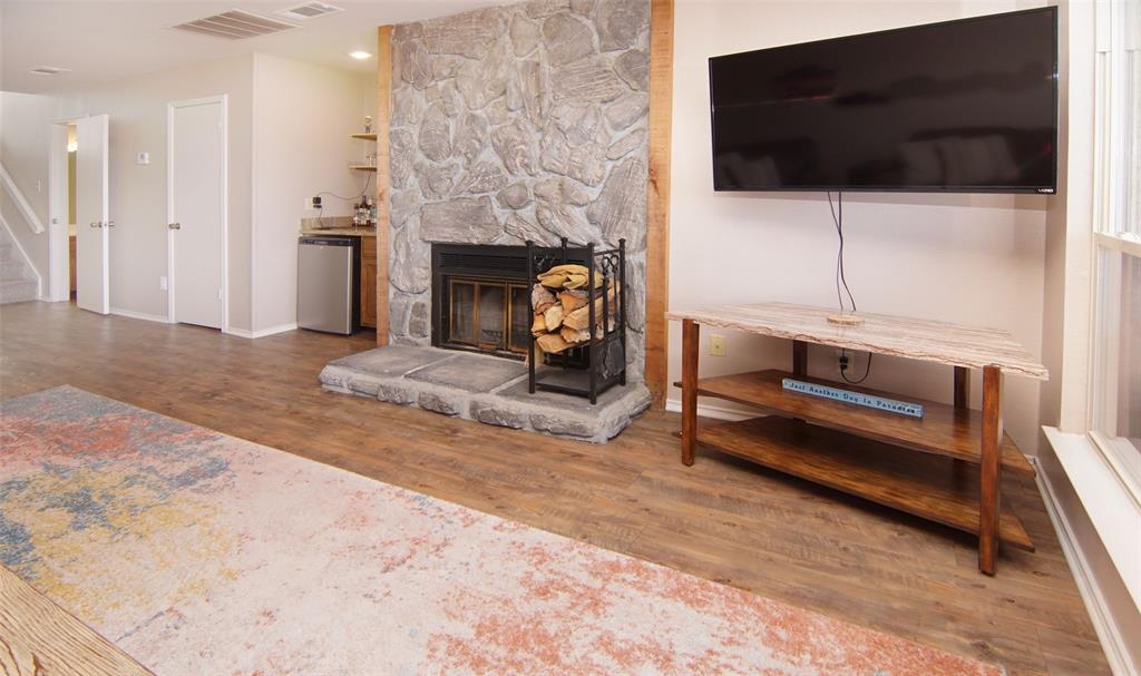 3109 Hells Gate Loop, Unit 59 Strawn, TX 76475 - Photo 3 of 25 a living room with furniture a flat screen tv and a fireplace