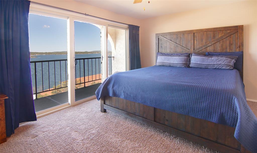 3109 Hells Gate Loop, Unit 59 Strawn, TX 76475 - Photo 10 of 25 a bedroom with a bed and a window