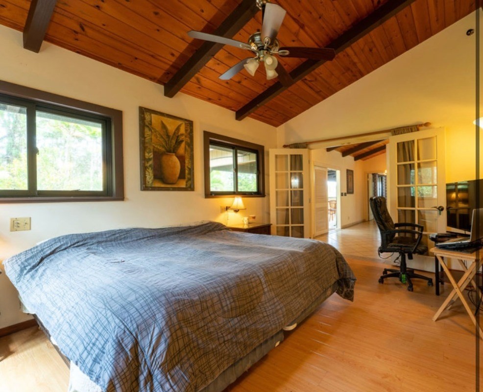 16-1339 Ao Rd Mountain View Mountain View, HI 96771 - Photo 13 of 24 a bed sitting in a spacious bedroom next to a window