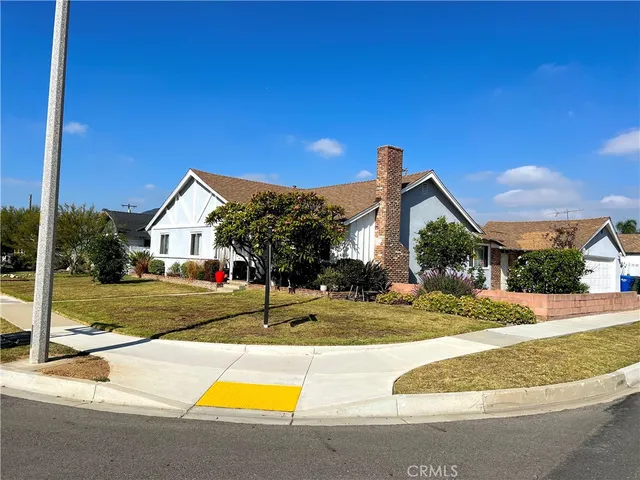 a view of a house with swimming pool and a small yard