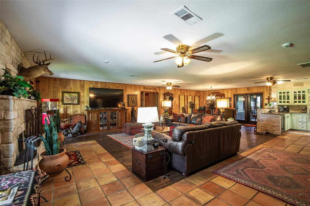 2043 Huddleston Road Sunset, TX 76270 - Photo 12 of 36 a living room with lots of furniture and chandelier