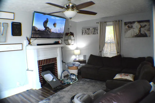 a living room with furniture and a fireplace