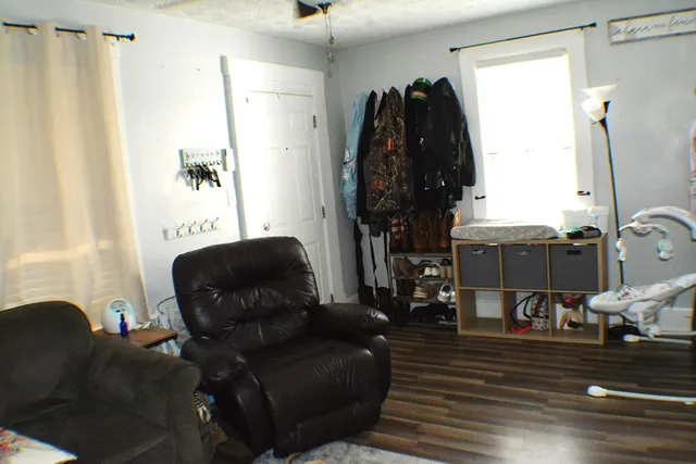 a living room with furniture and a walk in closet