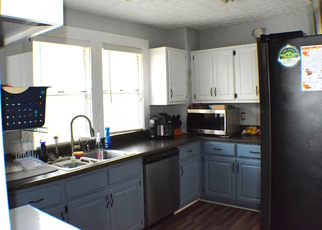 a kitchen with a sink cabinets and window