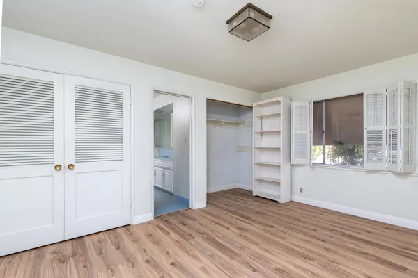 a view of a room with wooden floor and windows