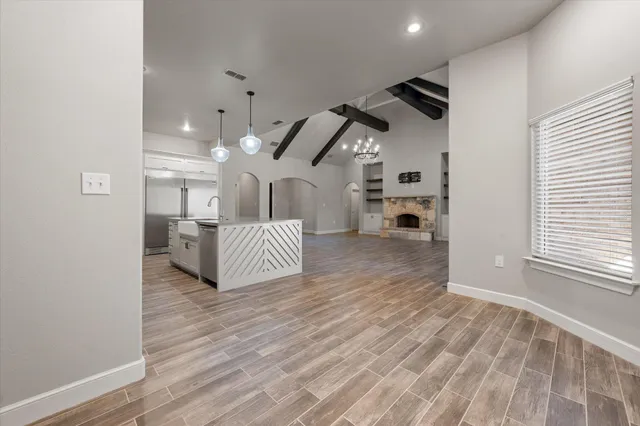 a view of a bedroom with wooden floor