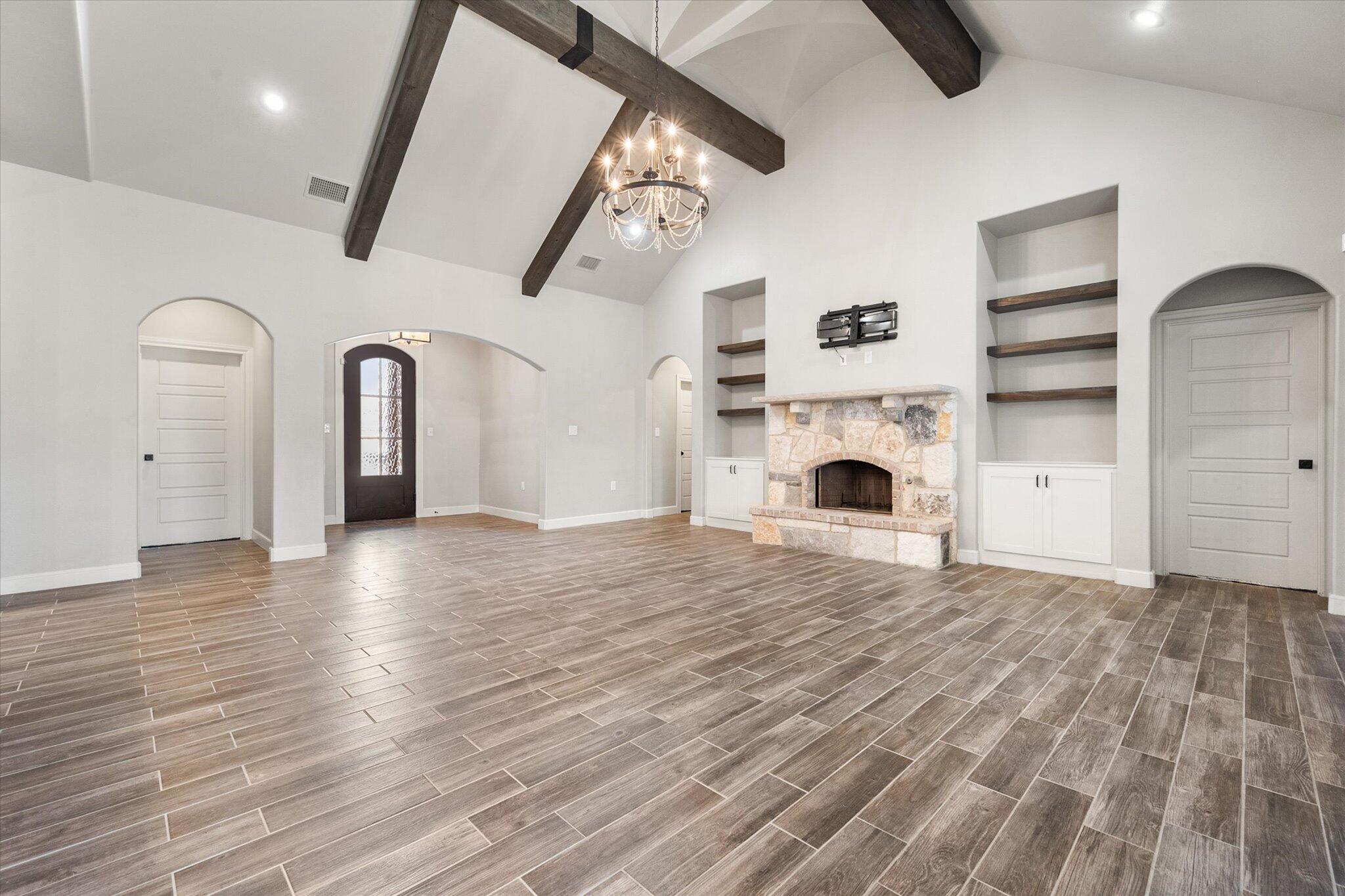 717 North 7th Street Wolfforth, TX 79382 - Photo 8 of 34 a view of empty room with fireplace and wooden floor
