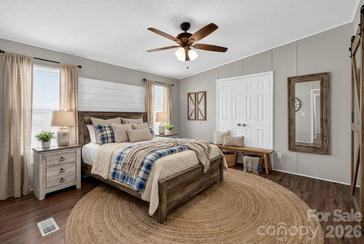 1118 Old Willis School Road Dallas, NC 28034 - Photo 12 of 17 a bedroom with a large bed and a chandelier
