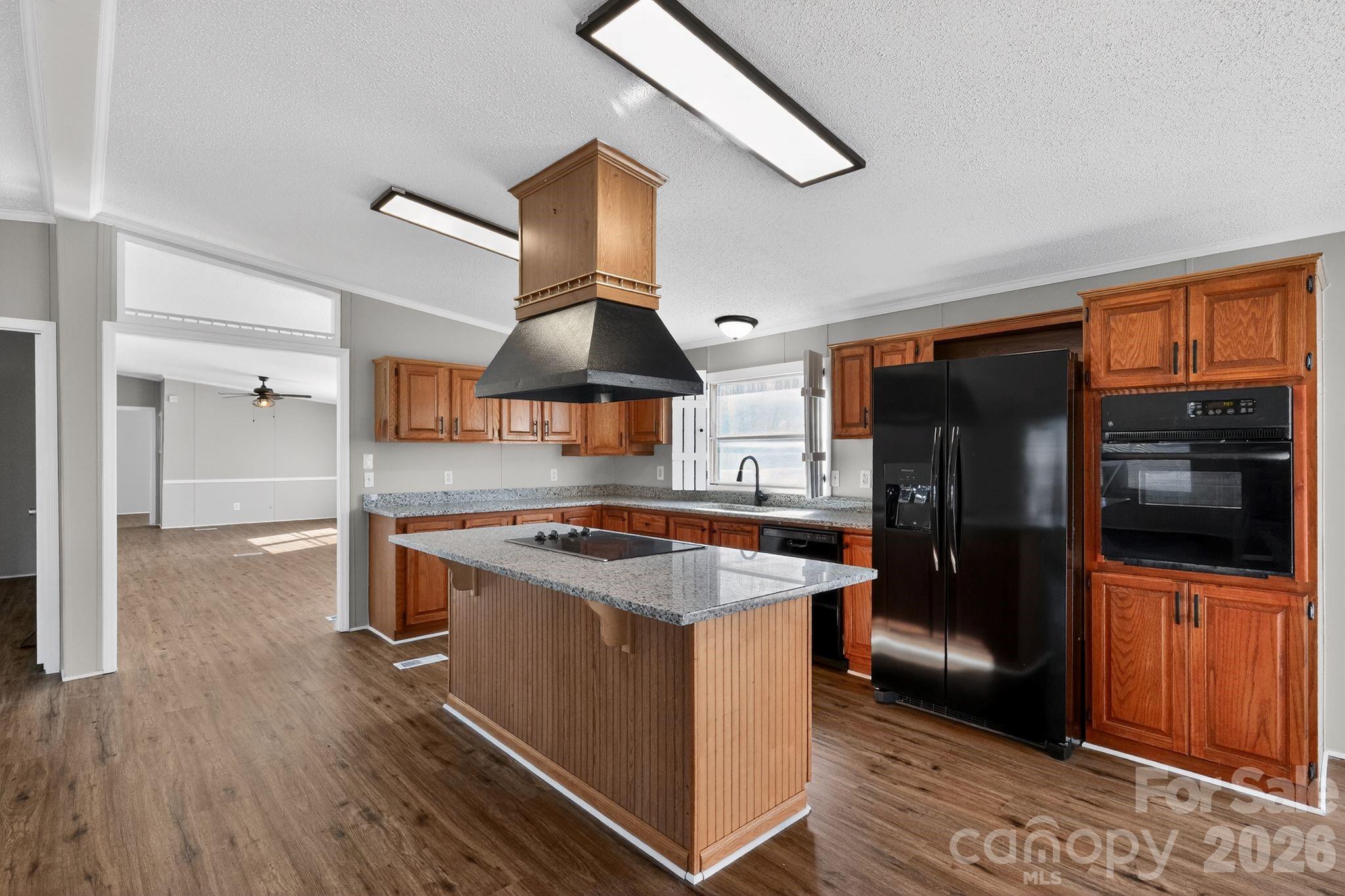 1118 Old Willis School Road Dallas, NC 28034 - Photo 8 of 17 a kitchen with stainless steel appliances granite countertop a refrigerator a sink and a stove