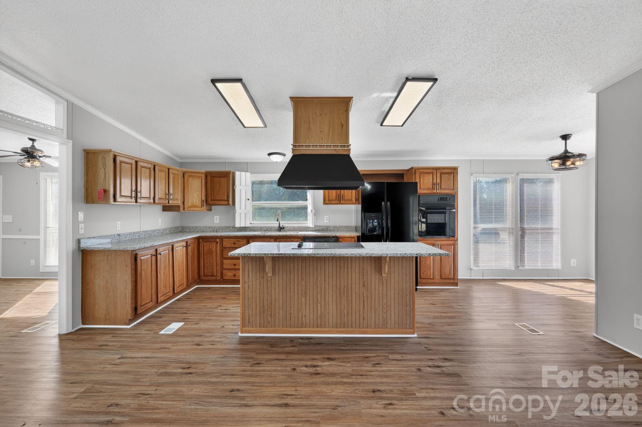 1118 Old Willis School Road Dallas, NC 28034 - Photo 10 of 17 a kitchen with stainless steel appliances granite countertop a stove a sink and a wooden floors