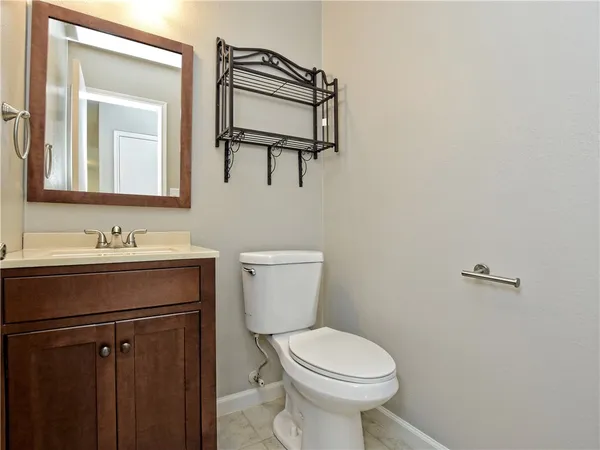 a bathroom with a sink toilet and mirror