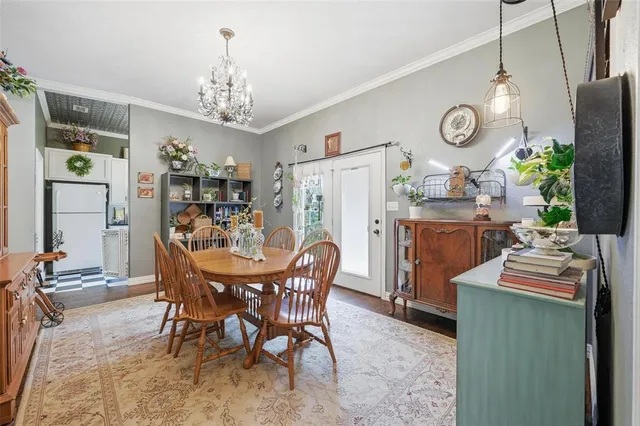 a view of a dining room with furniture and chandelier