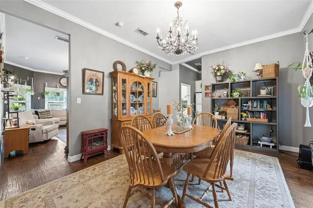 a view of a dining room with furniture wooden floor and a chandelier