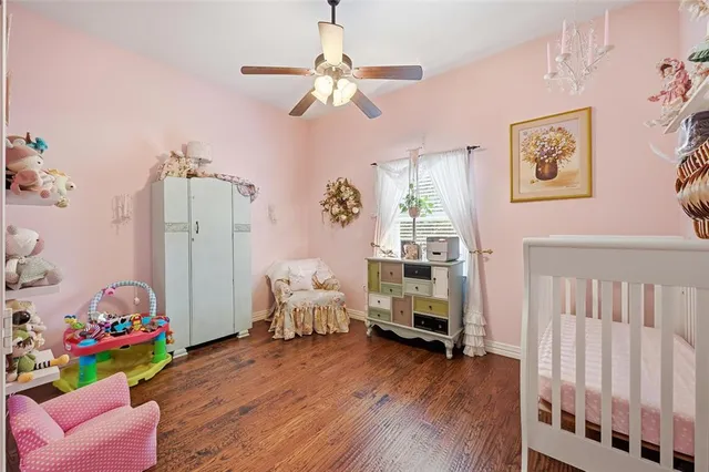 a bedroom with furniture and a wooden floor