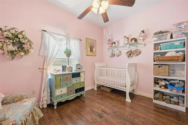 a bedroom with furniture and a wooden floor