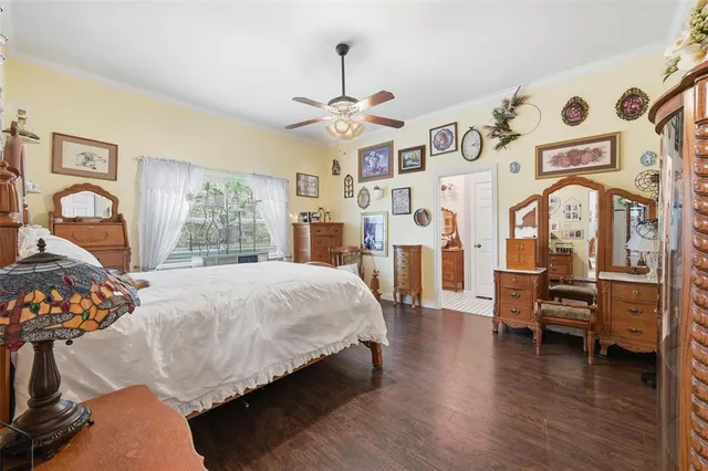 a bedroom with furniture and wooden floor